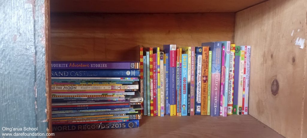 A wooden shelf with books on it